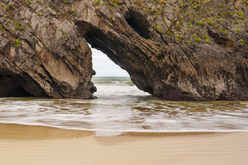 Pointed stone arch at Dehesa and San Antol&iacute;n de Bed&oacute;n beach, Naves, Asturias