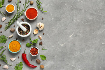 Composition with herbs and spices on grey grunge background