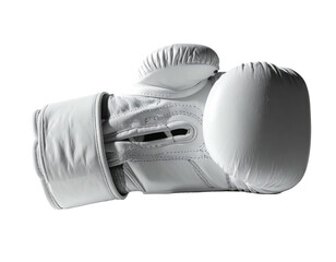 A singular white boxing glove, well lit, against a stark black background