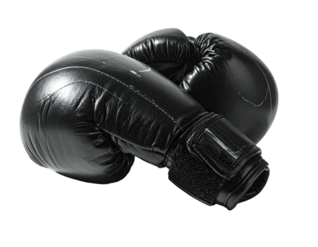 Two professional black boxing gloves, posed for a close-up with a black background