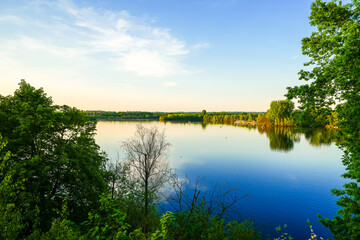 View of Lake Elbsee and the surrounding landscape. Idyllic nature by the lake at sunset near Düsseldorf.
