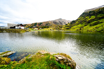 Fototapeta premium View of Lake Falkert in the Gurktal Alps and the surrounding landscape. Nature at a mountain lake in Carinthia. High mountain lake in Austria. 