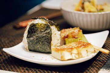 Japanese rice ball and miso dengaku tofu on a white plate — homemade comfort food