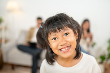 Joyful Family Moments: Capturing an innocent child's heartwarming smile, radiating pure joy and a sense of togetherness, framed within the warmth of a family's love. 