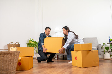 Moving Home: A couple lifts moving boxes, filled with their belongings, signifying the beginning of a new life in a new home, showcasing the start of their shared journey
