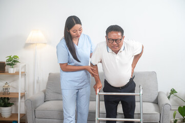 Caring Support: A compassionate caregiver helps an elderly gentleman with mobility assistance using a walking aid