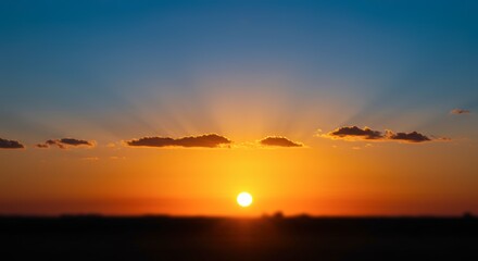 Vibrant sunset landscape with dramatic light and clouds over a silhouette horizon suitable for various applications