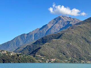 Majestic mountain landscape with lake Como and blue sky in sunlight, Dongo, Lombardy, Italy, October 2024