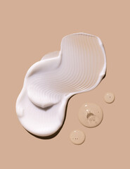 samples of cosmetic care products smear of cream texture on a beige background