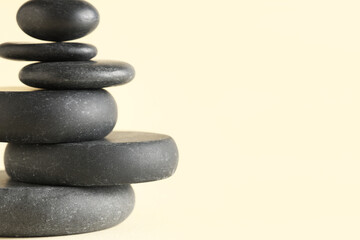 Stack of pebbles on yellow background. Zen concept