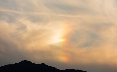 Faint Rainbow Colors Through Wispy Evening Clouds