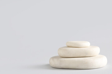 Stack of pebbles on grey background. Zen concept