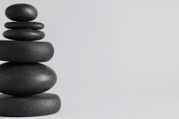 Stack of pebbles on grey background. Zen concept