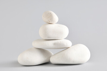 Stack of pebbles on grey background. Zen concept