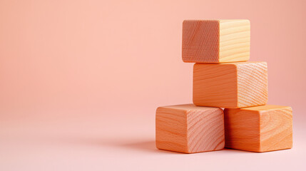 Obraz premium Stacked wooden blocks in soft peach tones create playful and inviting atmosphere, perfect for children activities or educational settings