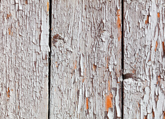 A wooden board with a lot of peeling paint