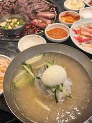 Authentic Pyongyang naengmyeon with chewy buckwheat noodles in cold, clear broth, offering a refreshing and delicate flavor. Perfect for traditional Korean cuisine menus and summer dishes.