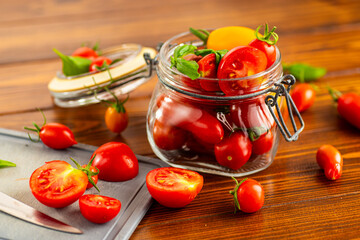 Rustic kitchen scene with tomatoes basil and jar