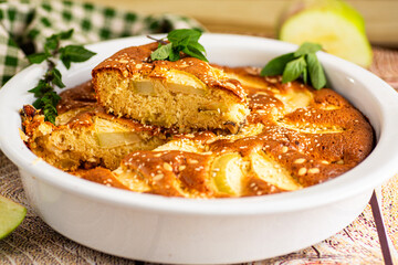 Ruddy apple pie with mint and golden crust close-up
