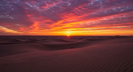 Spectacular sunset over desert dunes with vibrant colors and dramatic sky