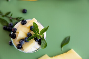 Healthy breakfast yogurt melon blueberries and mint leaf