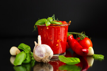 Organic tomato sauce with basil leaves and garlic bulbs