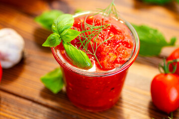 Fresh tomatoes garlic basil and herbs on wooden table