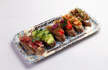 Various bruschettas on a plate.