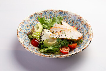 Chicken breast salad on a plate.