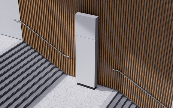 Modern architectural interior features a minimalist digital display stand beside a sleek staircase and warm wooden wall paneling creating a sophisticated ambiance for wayfinding and branding.
