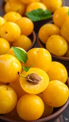 Close-up of yellow plums in bowls
