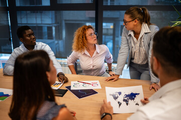 Business team discussing global strategy with diverse colleagues