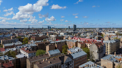 Fototapeta premium Aerial Drone View Of Riga Panorama In Latvia On A Sunny Spring Day Showcasing The Rooftops Of Houses The Vibrant City Center Historic Buildings And Barona Street Playground of the Downtown Sports Area