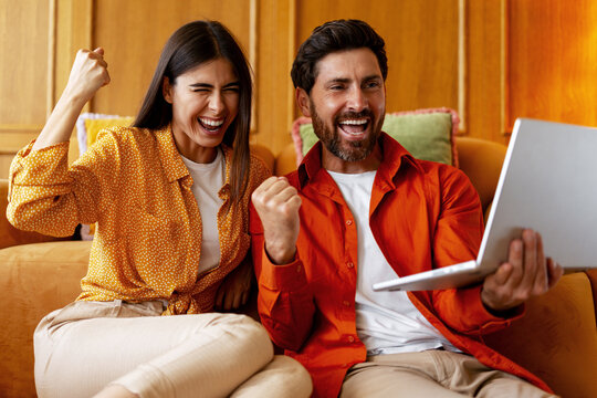 Couple feeling excitement winning online betting results. Happy woman and man having fun - Powered by Adobe