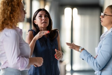 Group of businesswomen communicating using sign language indoors © Zoran Jesic