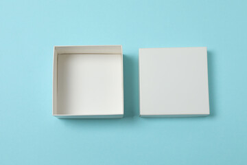 empty paper box with lid on blue background, top view

