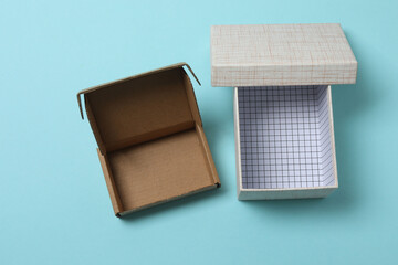 empty paper box with lid on blue background, top view
