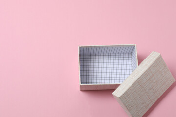 empty paper box with lid on pink background, top view
