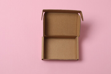 empty paper box with lid on pink background, top view
