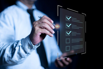 Businessman using pen to mark checkboxes, Performance checklist and tracking business performance, Online survey online exam Choosing the right answer in the exam.