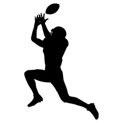 Silhouette of football player jumping to catch ball in mid-air
