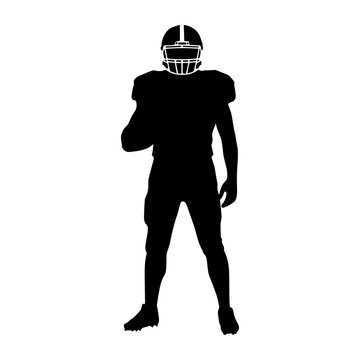 Silhouette of an American football player standing with ball
