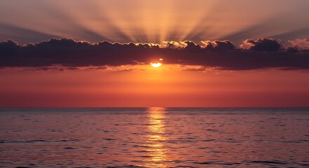 Vibrant sunset over ocean with radiant sun rays and calm water reflection