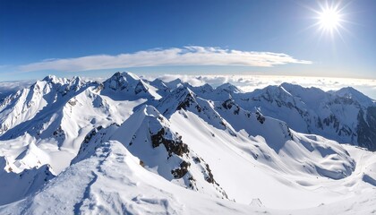Obraz premium Panoramic view of snow-capped mountain peaks under a clear blue sky