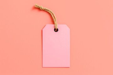 Blank pink label mockup with thick rope, centered empty price tag mockup on coral background for any company branding or logo