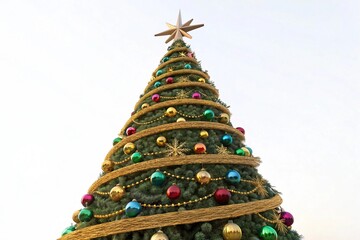 Grand outdoor Christmas tree decorated with ornaments and lights
