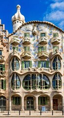 Fototapeta premium Whimsical Curved Building: Colorful Terra Cotta Tiles, Unique Windows, Organic Design ??
