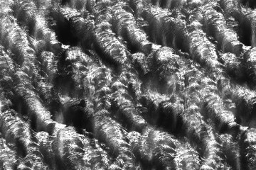 Dynamic abstract background featuring metallic swirl patterns in black and white tones. Perfect for modern design projects, industrial themes.