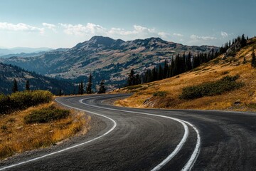 Naklejka premium A winding mountain road leads through a stunning landscape with vast views