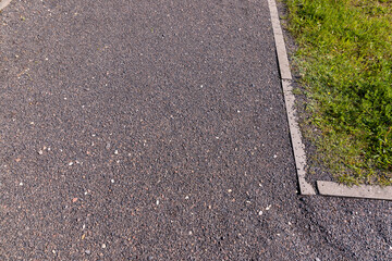 Obraz premium a narrow walking path in the park made of finely crushed rubble, not a wide path for pedestrians to walk in the park in sunny weather